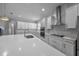Contemporary kitchen with quartz counters, stainless appliances, and white subway tile backsplash at 677 Brooks Field Dr, Winter Garden, FL 34787