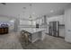 Gourmet kitchen features a large island with seating, stainless appliances and white cabinets at 677 Brooks Field Dr, Winter Garden, FL 34787