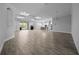 Spacious open-concept area showcasing wood-look tile flooring and recessed lighting, seamlessly connecting living spaces at 677 Brooks Field Dr, Winter Garden, FL 34787