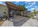 A large backyard patio area with pavers, a wooden pergola, a screened lanai, and tropical plants at 677 Brooks Field Dr, Winter Garden, FL 34787
