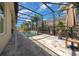 A screened pool area with a large swimming pool, a waterfall feature, and a patio at 677 Brooks Field Dr, Winter Garden, FL 34787