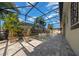 A backyard pool with a screened enclosure, pavers, lights, and tropical landscaping at 677 Brooks Field Dr, Winter Garden, FL 34787