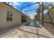 A long shot of a screened pool with a fountain feature and a covered patio area with seating at 677 Brooks Field Dr, Winter Garden, FL 34787