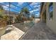A beautiful backyard pool surrounded by a screened enclosure, pavers, and tropical landscaping at 677 Brooks Field Dr, Winter Garden, FL 34787
