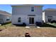 Large backyard with a patio, seating, and lush green grass at 6846 Wilson Hammock Ave, Groveland, FL 34736