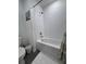 Bright bathroom with white subway tile, a tub with shower, and a shower curtain at 6846 Wilson Hammock Ave, Groveland, FL 34736
