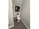 Charming half bathroom featuring gray walls, tiled flooring, and a decorative storage cabinet at 6846 Wilson Hammock Ave, Groveland, FL 34736