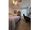 This carpeted bedroom offers a ceiling fan, natural light, and neutral walls perfect for any decor style at 6846 Wilson Hammock Ave, Groveland, FL 34736