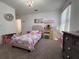 Bedroom with a cozy bed, dresser, and decorative wall art at 6846 Wilson Hammock Ave, Groveland, FL 34736