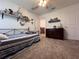 This carpeted bedroom offers a shelf, ceiling fan, and neutral walls perfect for any decor style at 6846 Wilson Hammock Ave, Groveland, FL 34736