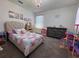 Bright bedroom with a cozy bed, princess decor, and chandelier lighting at 6846 Wilson Hammock Ave, Groveland, FL 34736