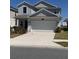 Charming two-story home with a well-maintained lawn and a two-car garage at 6846 Wilson Hammock Ave, Groveland, FL 34736