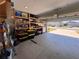 Spacious garage with built-in shelving, providing ample storage space for tools and equipment at 6846 Wilson Hammock Ave, Groveland, FL 34736