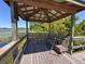 Lakefront gazebo with seating, offering a serene spot to relax and enjoy the views at 6846 Wilson Hammock Ave, Groveland, FL 34736