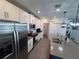 Modern kitchen with stainless steel appliances and a large island with a gray countertop at 6846 Wilson Hammock Ave, Groveland, FL 34736