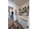Convenient laundry room with storage shelves, washer, and dryer at 6846 Wilson Hammock Ave, Groveland, FL 34736