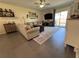Comfortable living room with large sliding glass doors and decor at 6846 Wilson Hammock Ave, Groveland, FL 34736