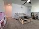 A bright living room with neutral furniture, a black coffee table, and a toy kitchen at 6846 Wilson Hammock Ave, Groveland, FL 34736