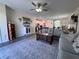 Open-concept living space with stylish decor and seamless flow to the kitchen at 6846 Wilson Hammock Ave, Groveland, FL 34736