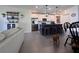Open living area with kitchen island, dining table and comfy seating at 6846 Wilson Hammock Ave, Groveland, FL 34736