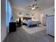 Spacious main bedroom featuring a ceiling fan, soft carpet, and soothing décor at 6846 Wilson Hammock Ave, Groveland, FL 34736