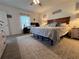 Inviting main bedroom featuring a soft carpet, natural light, and simple decor at 6846 Wilson Hammock Ave, Groveland, FL 34736