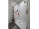 Clean white shower stall with shower curtain, shelves, and shower head at 6846 Wilson Hammock Ave, Groveland, FL 34736