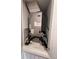 Utility closet containing an HVAC system, a Carrier unit, and household supplies at 6846 Wilson Hammock Ave, Groveland, FL 34736