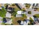 Bird's-eye view of homes arranged around a cul-de-sac, highlighting driveways and landscaping at 728 Tangerine Dr, The Villages, FL 32159