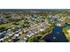 An aerial view shows a well-maintained community with waterfront homes and a golf course nearby at 728 Tangerine Dr, The Villages, FL 32159