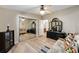 Bedroom features wood-look floors, ceiling fan, mirrored closet, and natural light at 728 Tangerine Dr, The Villages, FL 32159