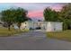 Charming single-story home with a well-maintained lawn, attached garages, and a long driveway at 728 Tangerine Dr, The Villages, FL 32159
