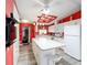 Bright kitchen with white cabinets, island with seating, and modern appliances at 728 Tangerine Dr, The Villages, FL 32159