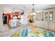 Open-concept kitchen and dining area featuring white cabinetry, an island, and modern appliances at 728 Tangerine Dr, The Villages, FL 32159