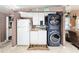 Laundry room features modern washer and dryer and built-in cabinets and sink at 728 Tangerine Dr, The Villages, FL 32159