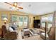 Bright living room with tile flooring, neutral furniture, large windows, and stylish decor at 728 Tangerine Dr, The Villages, FL 32159