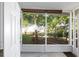 Bright sunroom featuring tiled floors, a large window with views of the lush green backyard at 728 Tangerine Dr, The Villages, FL 32159