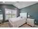Comfortable bedroom features a vaulted ceiling, bright windows, and stylish decor at 7669 Chastain Cir, Middleton, FL 34762