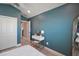 Bedroom with blue accent wall features a vanity, ensuite, and closet at 7669 Chastain Cir, Middleton, FL 34762