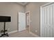 Minimalist bedroom with closet features a tv and light colored walls at 7669 Chastain Cir, Middleton, FL 34762