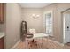 Bright breakfast nook with white desk, modern light fixture and natural light at 7669 Chastain Cir, Middleton, FL 34762