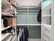 Walk-in closet with custom shelving and storage solutions to maximize organization and space at 7669 Chastain Cir, Middleton, FL 34762