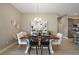 Charming dining area featuring a modern table and chairs, stylish decor, and an open view of the kitchen at 7669 Chastain Cir, Middleton, FL 34762