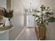 Inviting entryway with chandelier, console table and decorative plants at 7669 Chastain Cir, Middleton, FL 34762