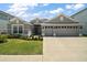 Lovely single-story home with a manicured lawn and a spacious three-car garage at 7669 Chastain Cir, Middleton, FL 34762