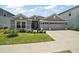 Beautiful single-story home with a manicured lawn and a spacious three-car garage at 7669 Chastain Cir, Middleton, FL 34762
