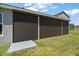 Exterior view of the back porch with built-in sun shades, providing shade and privacy at 7669 Chastain Cir, Middleton, FL 34762