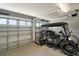 Well-lit two-car garage with ample storage and space for a golf cart and lawn equipment at 7669 Chastain Cir, Middleton, FL 34762