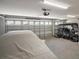 Spacious two-car garage with an automatic door, storage, and room for vehicles and equipment at 7669 Chastain Cir, Middleton, FL 34762