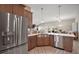 Stainless steel appliances and undermount sink accent the large kitchen with wood cabinets at 7669 Chastain Cir, Middleton, FL 34762